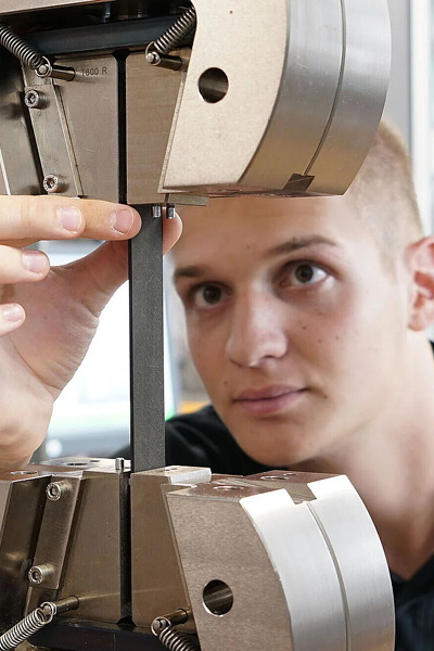 Engineer testing a composite sample in a ZwickRoell machine Engineer testing a composite sample in a ZwickRoell machine